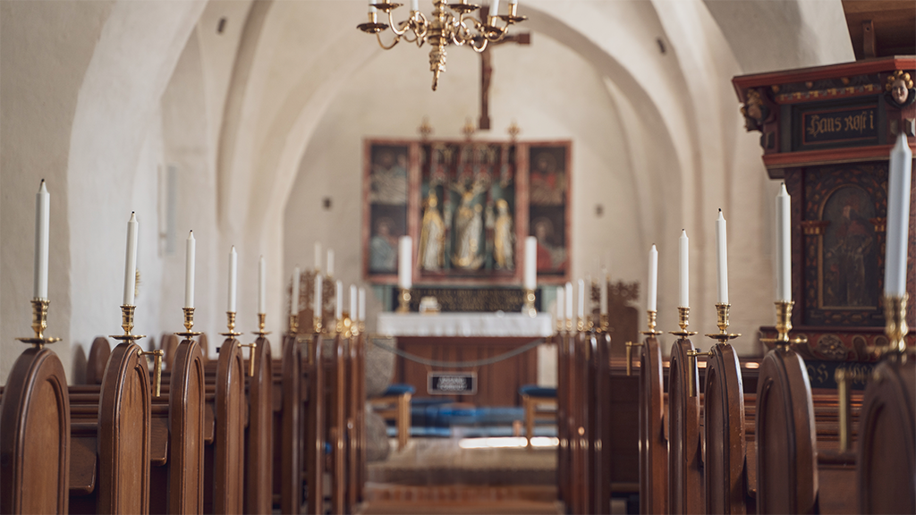 Benches and the altar inside Tunø Church.