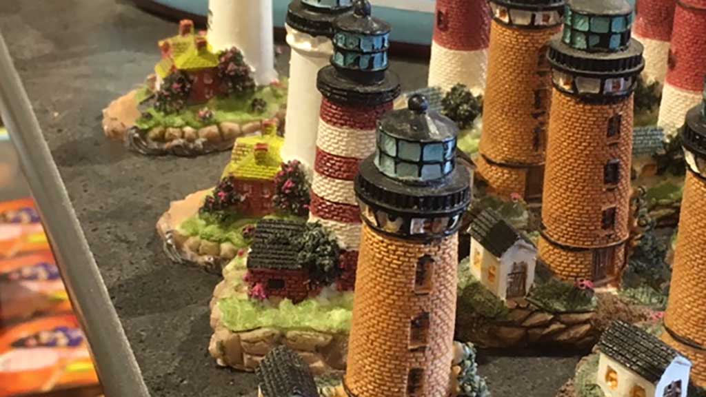 Small lighthouse souvenirs on the shelves at Buchs Boghandel