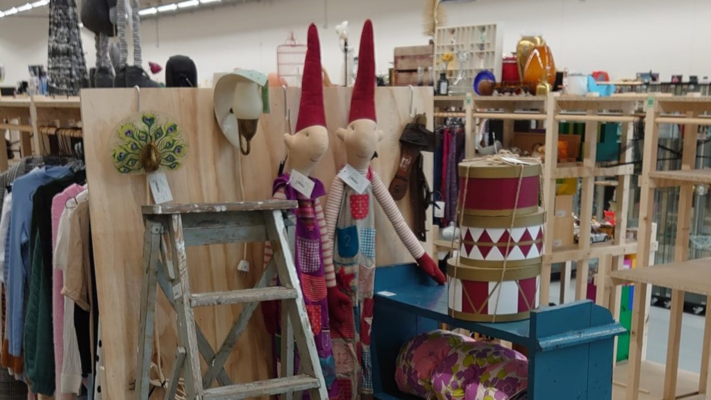 Christmas decorations and second-hand items on the shelves at the flea market Kirppu in Horsens