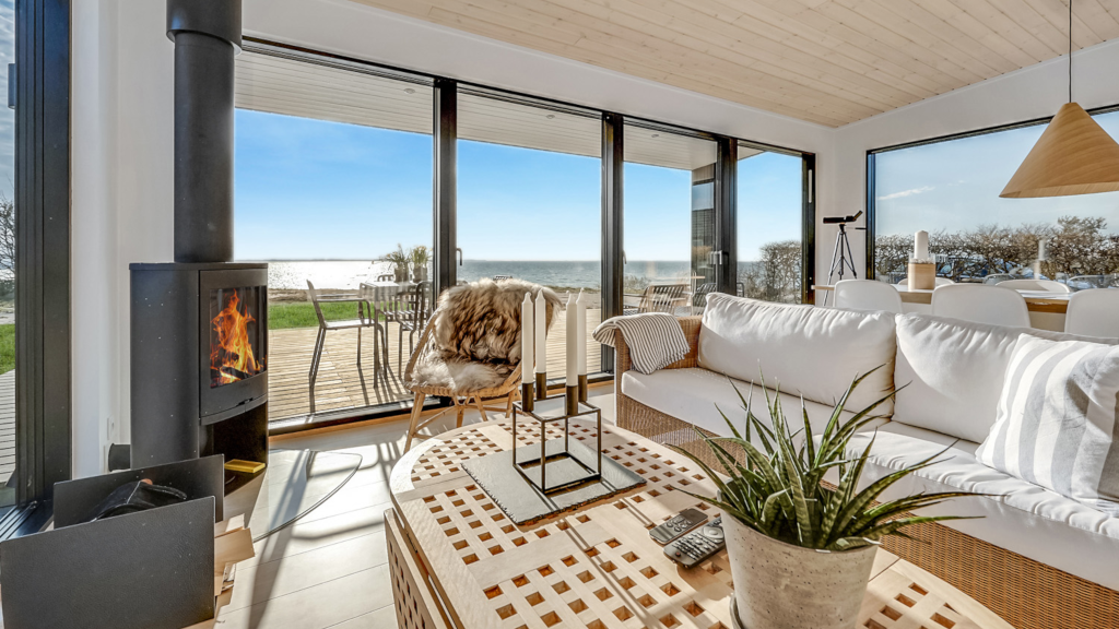 Living room in a summer house with a sea view and a wood-burning stove