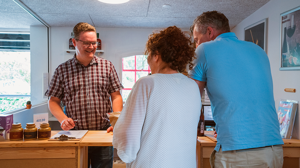 A couple purchasing items at the mill shop in Uldum Mill Museum