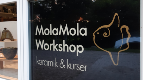 Skilt i vinduet ved indgangen til MolaMola Workshop i Voervadsbro