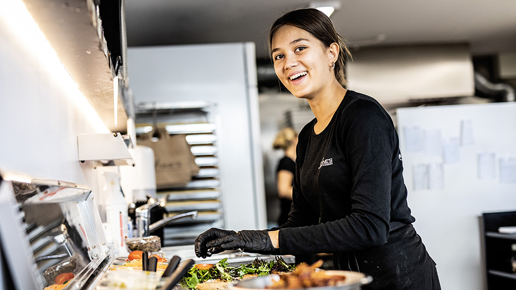 Employee preparing a salad at Anne's Frokost & Sandwich in Odder