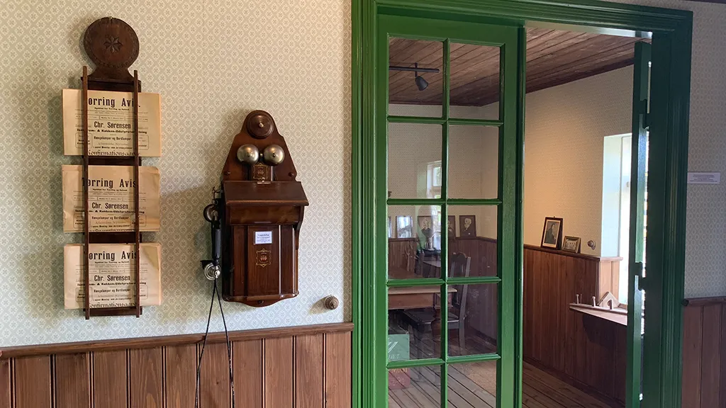 Restaureret historisk bygning med gammel telefon og gamle aviser på Hjortsvang frilandsmuseum nær Uldum og Gudenåen