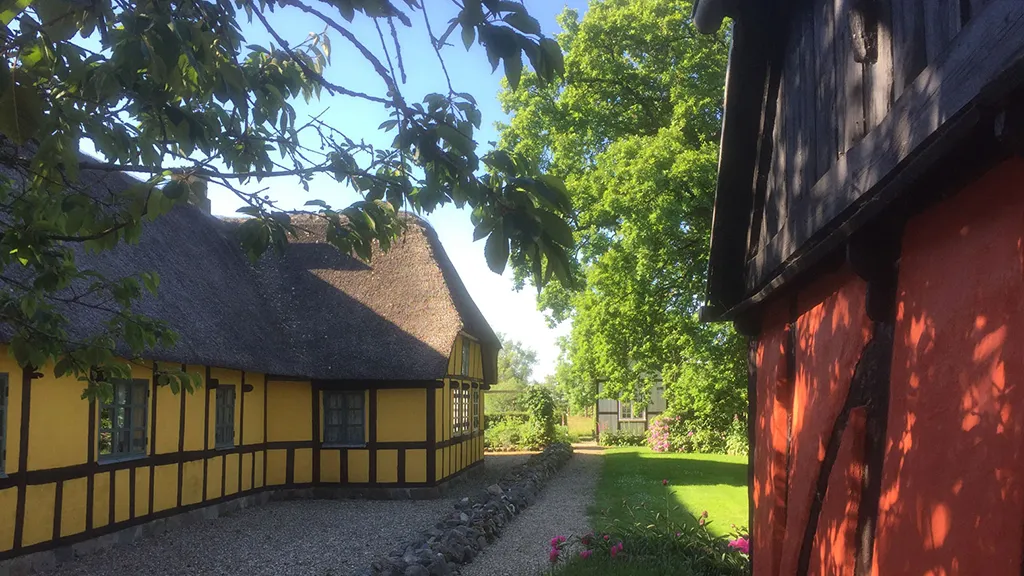 Gamle bygninger med bindingsværk og stråtag ved Hjortsvang Museum tæt på Uldum og Gudenåen