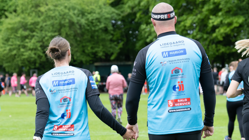 A couple walking hand in hand at Den Genfundne Bro Løbet