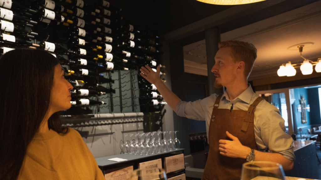 A waiter at Jørgensens Hotel Wine Bar presents the large selection of wines