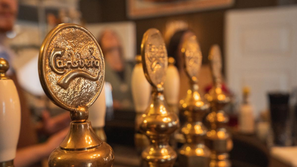 Old-fashioned brass draft beer taps from Carlsberg at Jørgensens Hotel Wine Bar