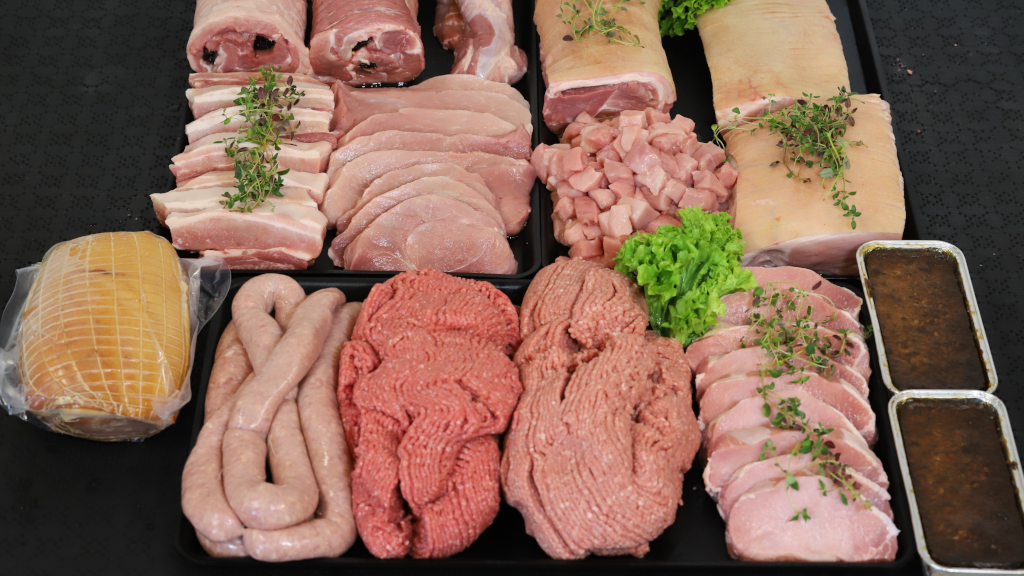 A selection of meat products from Bjerre Kød, including ham, medister sausage, minced meat, pork, and chops