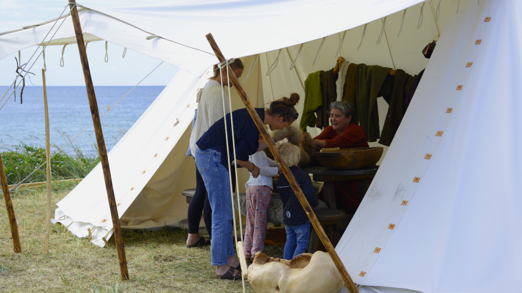 Mother and son are looking at goods in a Viking tent on Tunø.