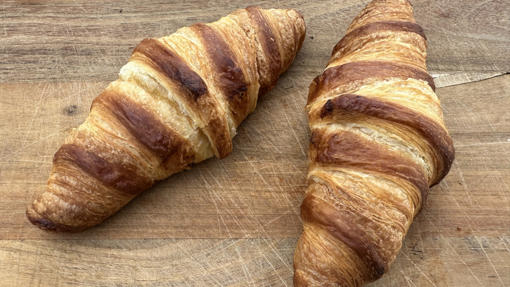 Two croissants on a table at Seia Sourdough Bakery