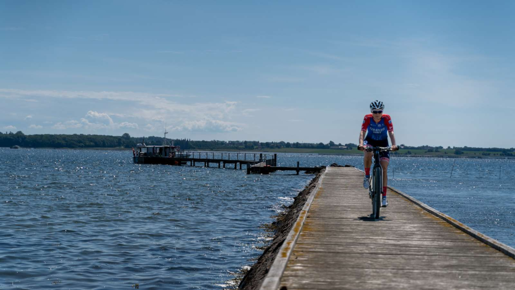 Cyclist Julie Leth cycling on a bridge on Alrø in front of the bike ferry