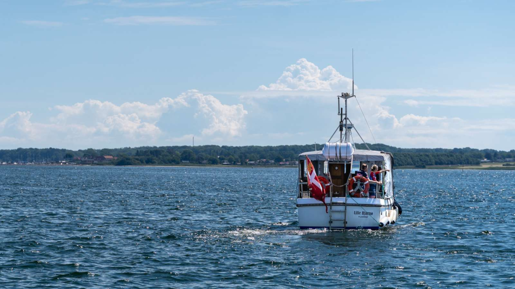 The bicycle ferry is sailing on Horsens Fjord with cyclists Julie Leth and Lasse Norman Leth on board