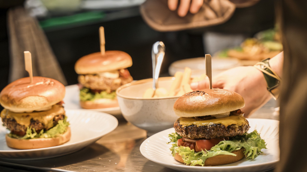 Chef plating burgers at Mejeriet Tunø