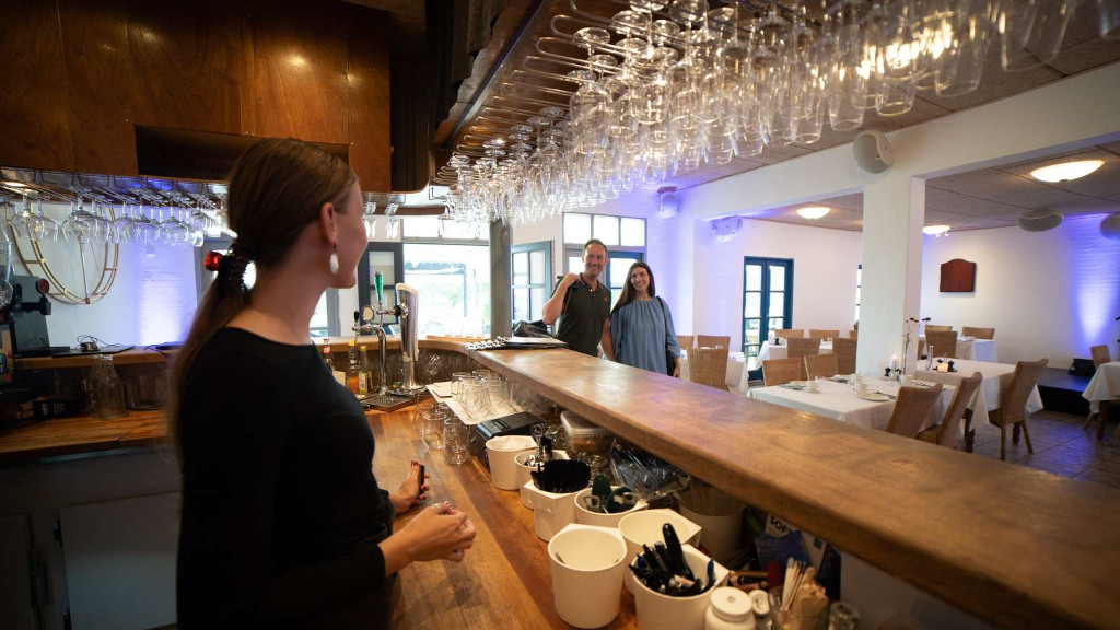 Waiter standing at the bar at Mejeriet Tunø