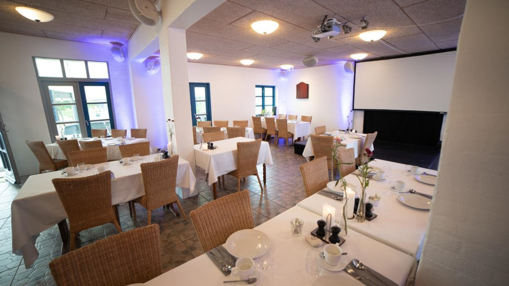 Set tables in the restaurant at Mejeriet Tunø