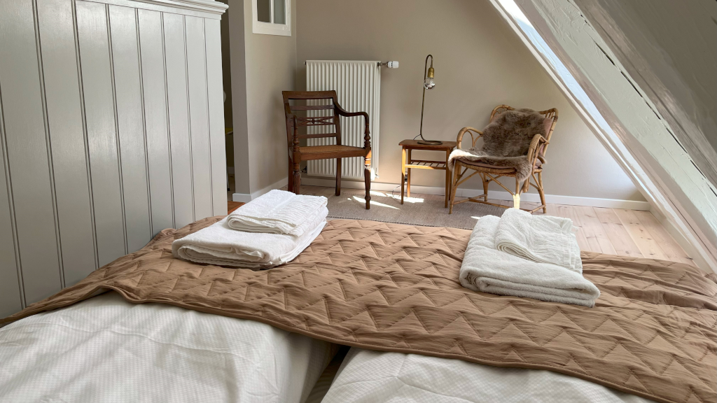 A made bed in a room at Reballegaard