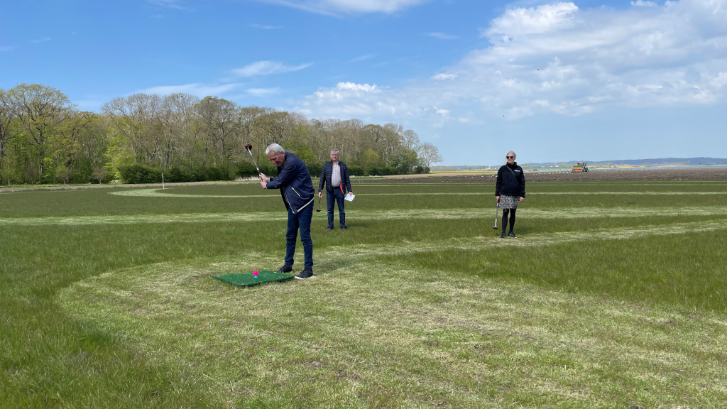 Three elderly people playing park golf at Hjarnø Camping