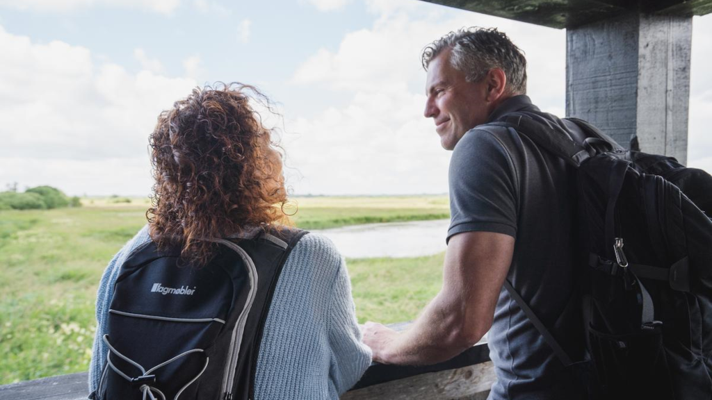 A couple enjoying the view from the birdwatching tower in Uldum Marsh.