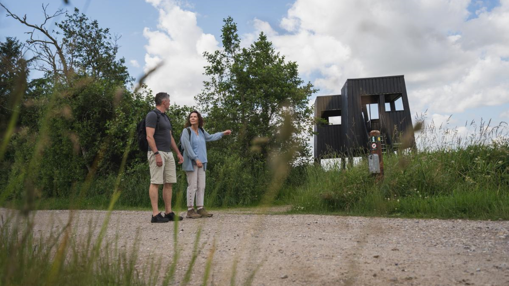 A couple pointing at the birdwatching tower in Uldum Marsh.