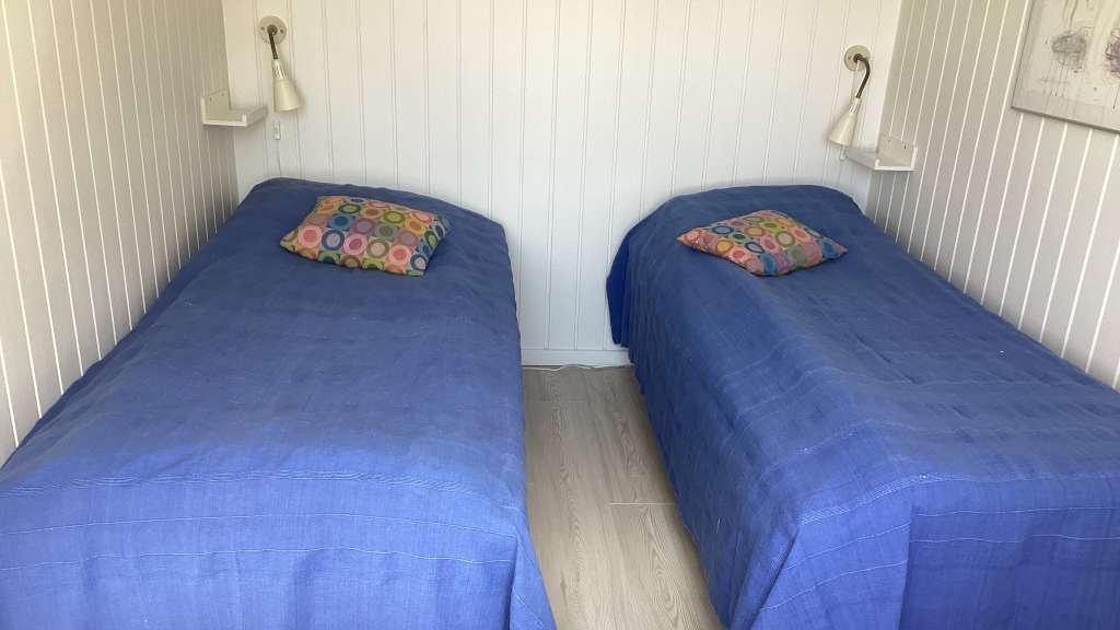 Two made single beds in a room at Anneks127