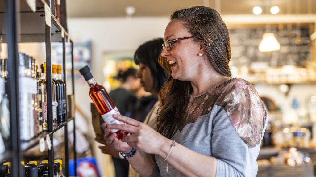 Eine Frau schaut sich Öle im Geschäft Spisekammeret an.