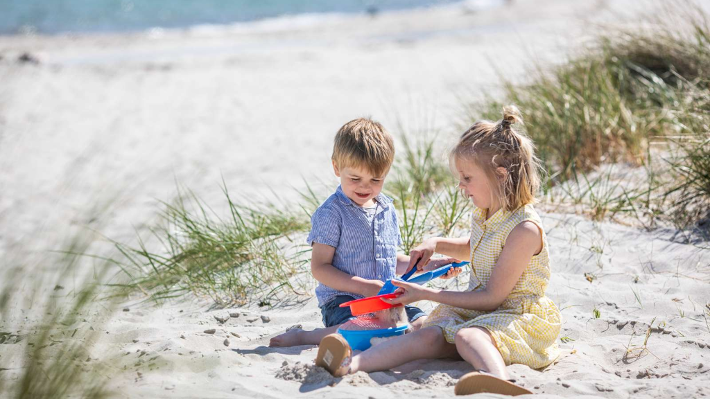 Two children playing with beach toys at Saksild Strand
