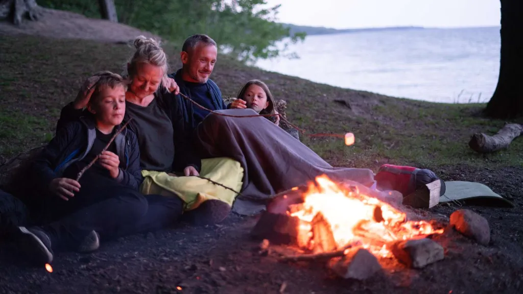 A family sitting around a campfire in Staksrode Forest