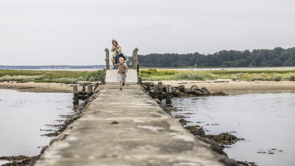 A boy running on a bridge on Hjarnø