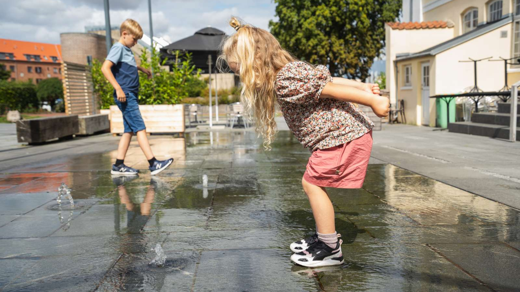 Children playing in the fountain at Police Square in Odder