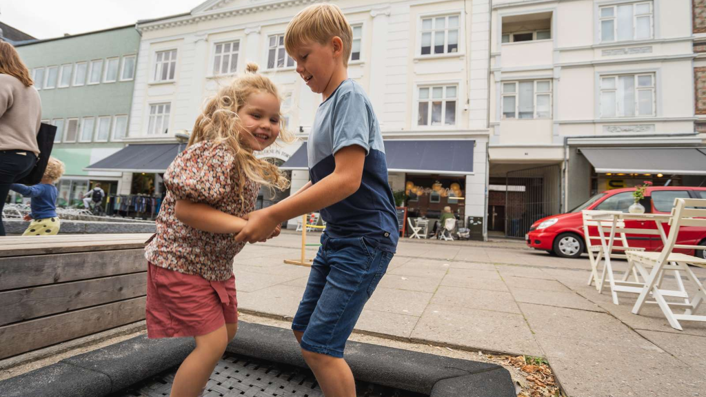 A boy and a girl jumping on a trampoline in Odder