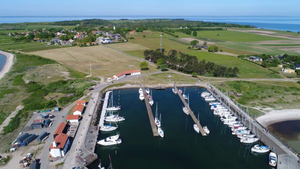 Drone photo of sailboats in the marina at Tunø, with the village in the background