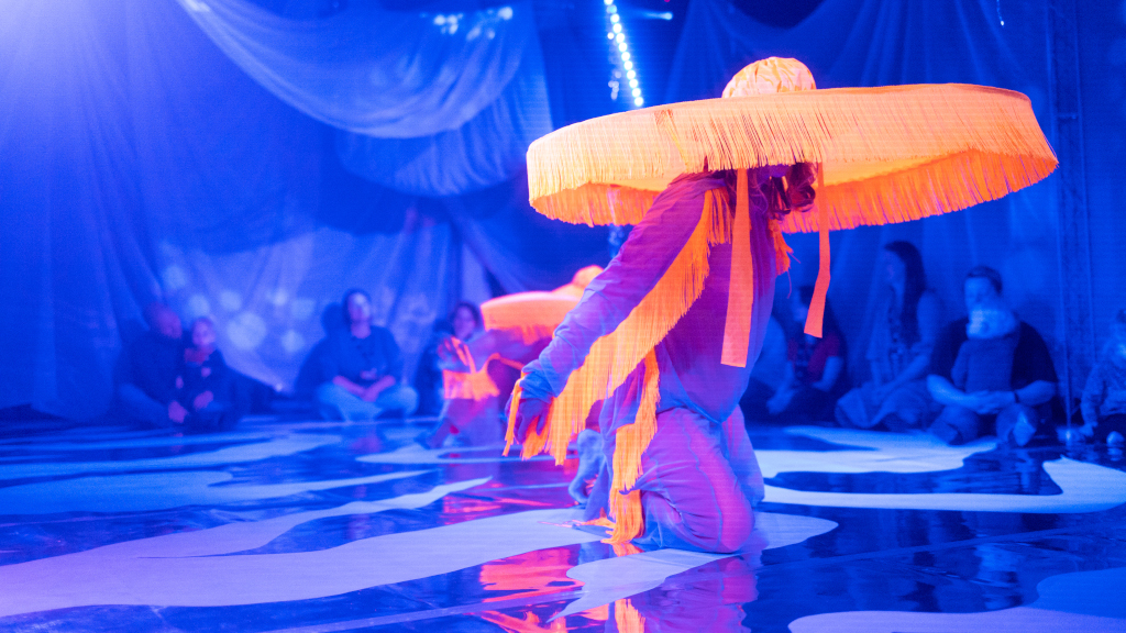 Children's theater performance with large hats
