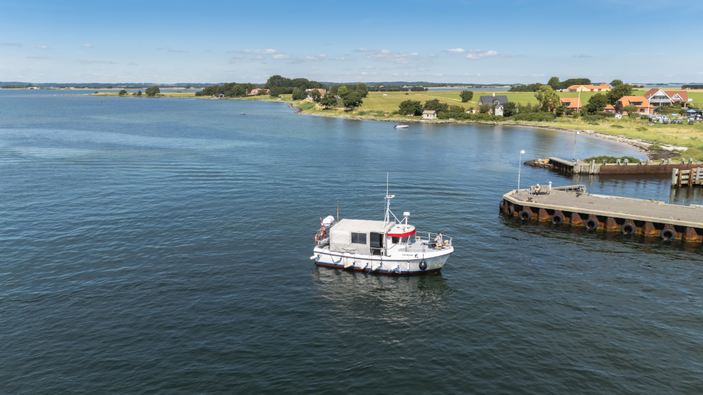 Aerial photo of the Alrø-Hjarnø Bicycle Ferry docked at the pier on Hjarnø