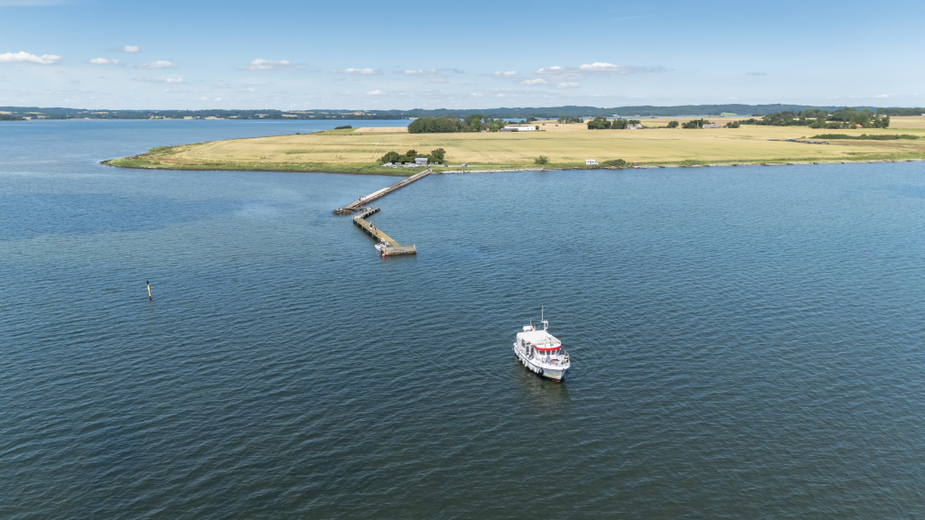 Aerial photo of the bicycle ferry Alrø-Hjarnø sailing away from Alrø