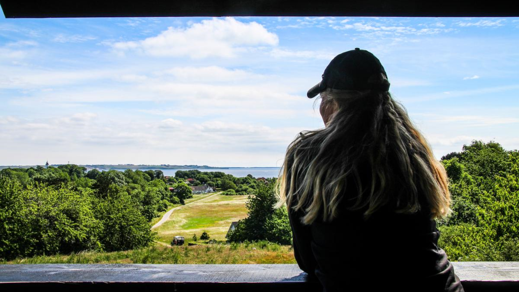 A woman looks out from the observation tower on Tunø