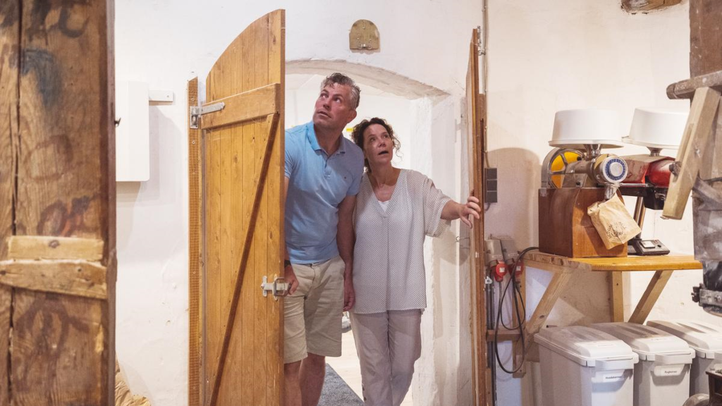 A couple walks through the doors to an exhibition room at Uldum Mill