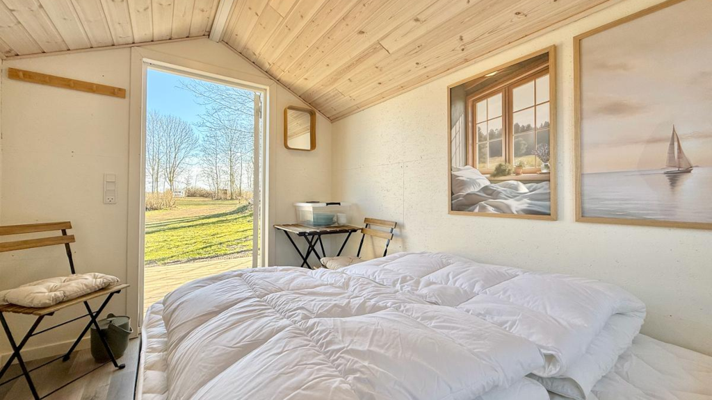 A bright two-person cabin at Campingpladsen Endelave seen from the inside