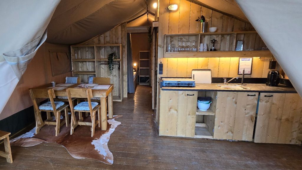 Safari glamping tent with kitchen, dining area and sleeping spaces