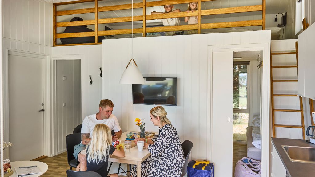 Family in a cosy luxury double cabin for six people at Horsens City Camping