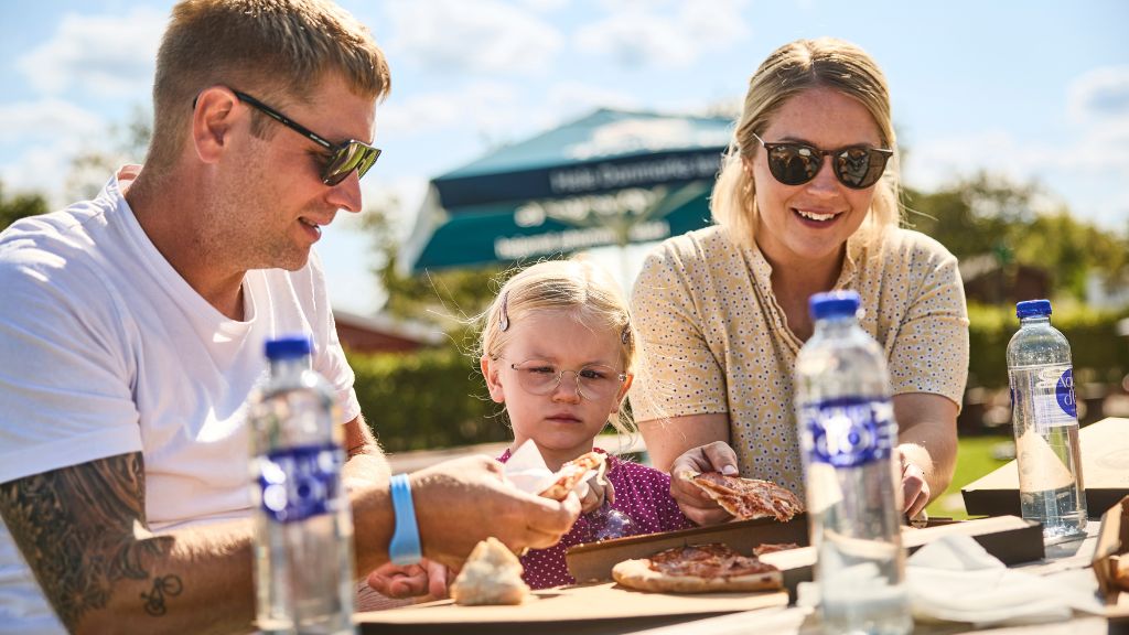 Family at Horsens City Camping eating pizza