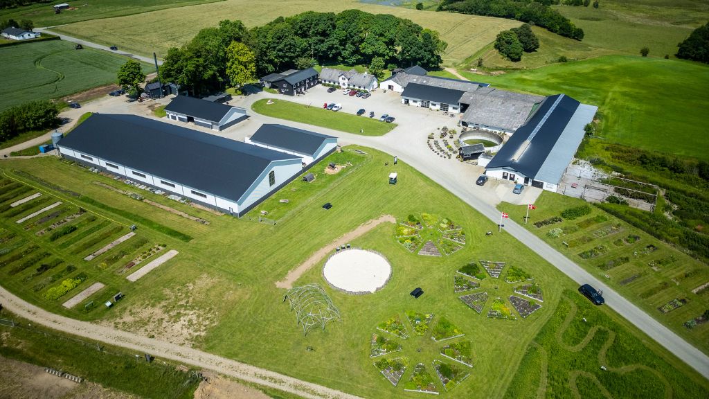Drone photo of Tinnegaard Farm Shop and visitor farm, showing the entire area with kitchen gardens and surrounding grounds.