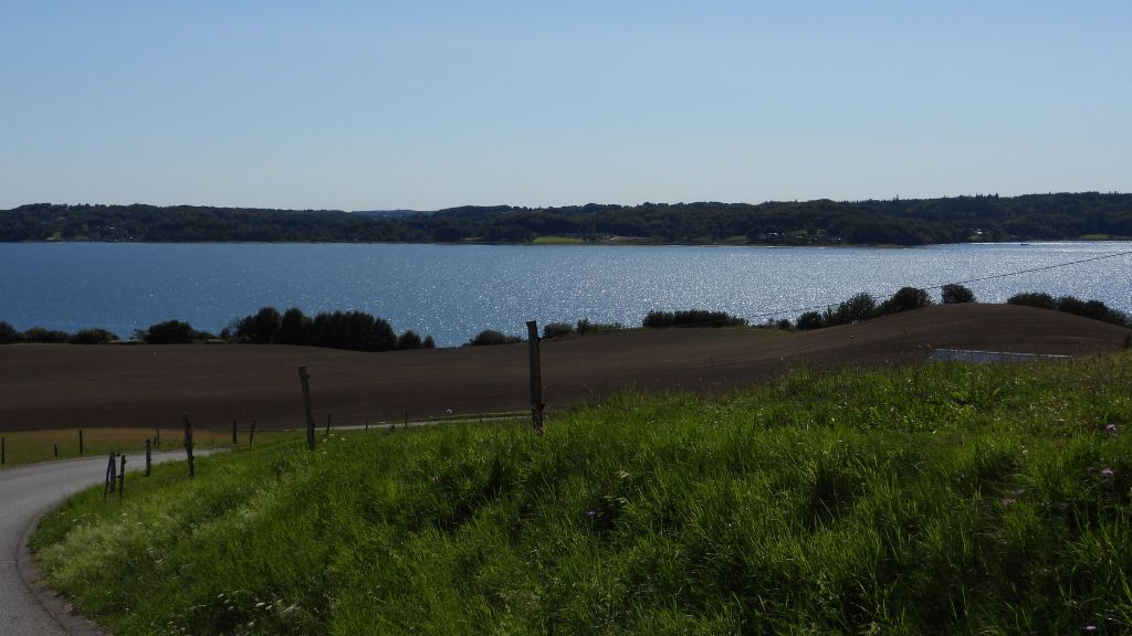 Daugård – Vejle Fjord, road and landscape on a spring day with blue skies.
