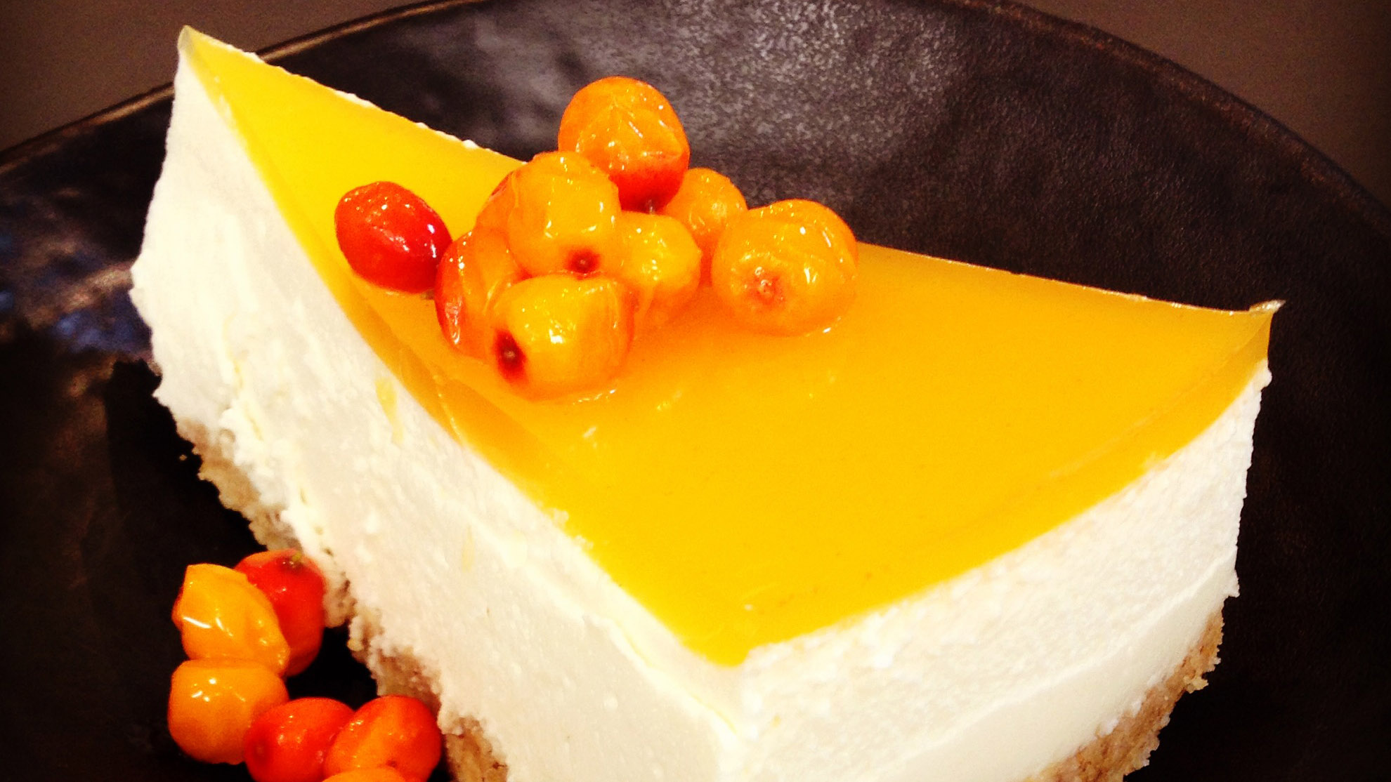 Cake with a yellow topping and berries at Café Knarr
