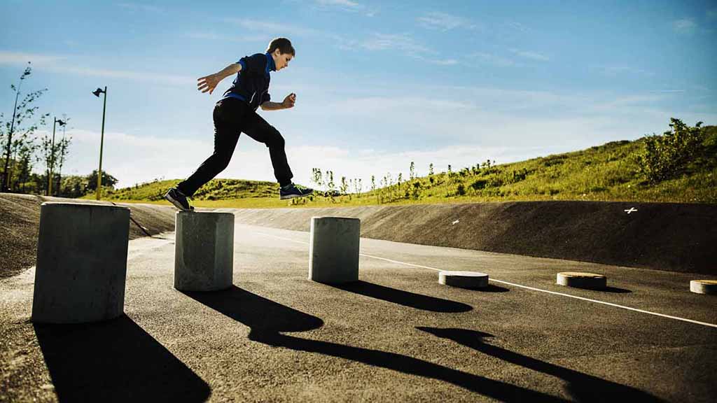 Child jumping between concrete blocks at Rabalder Parken