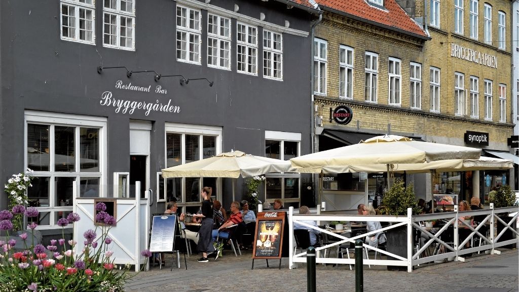 Facade and outdoor seating at Restaurant Bryggergården in the city.
