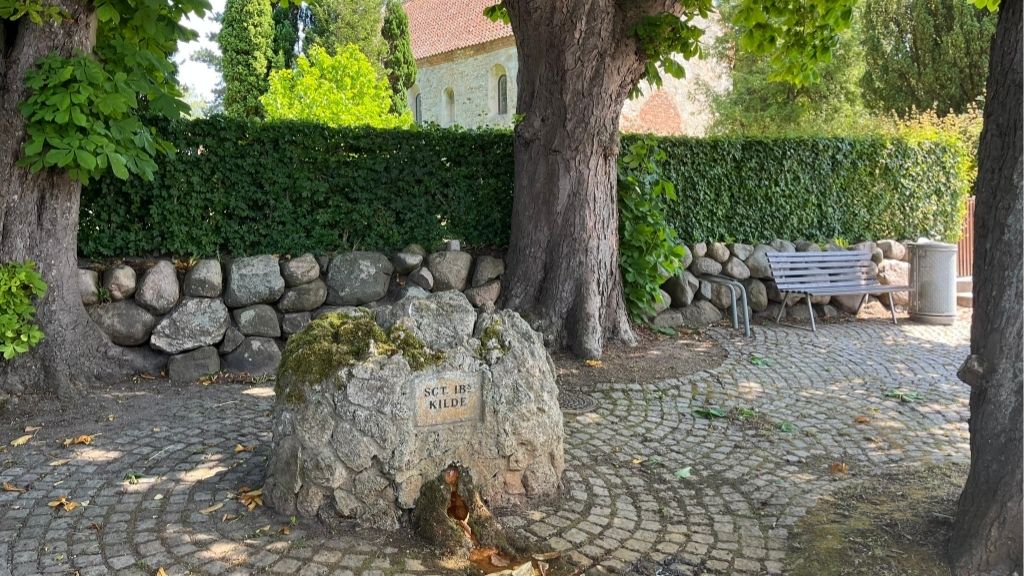 Sankt Ib Spring in Roskilde with stone source under trees near the Cathedral.