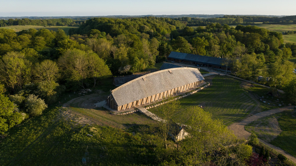 Aerial View of the Royal Hall at Land of Legends, Surrounded by Green Fields and Forest.