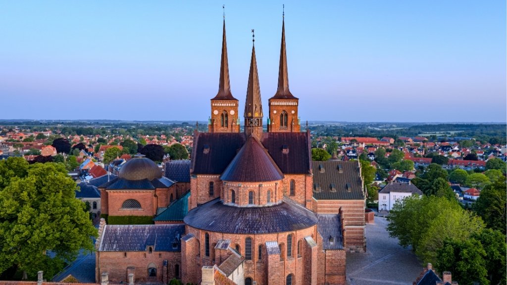 Aerial view of Roskilde Cathedral overlooking the town and surrounding landscape.