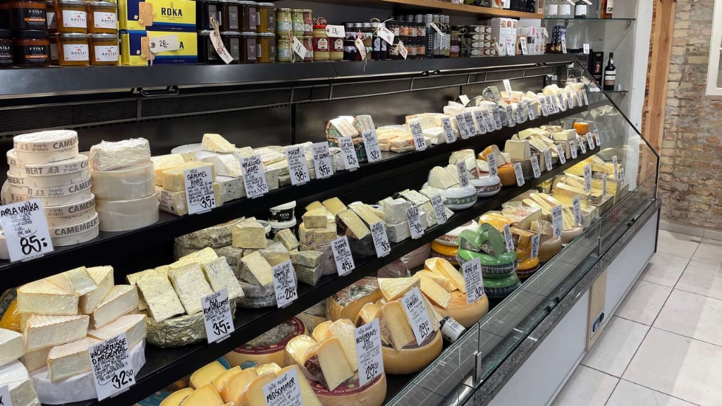 Cheese counter at Caseus Ost & Delikatesser with a wide selection of specialty cheeses.
